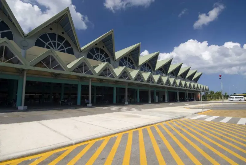 Terminal of Samaná El Catey International Airport with its peaked green roofs (AZS)